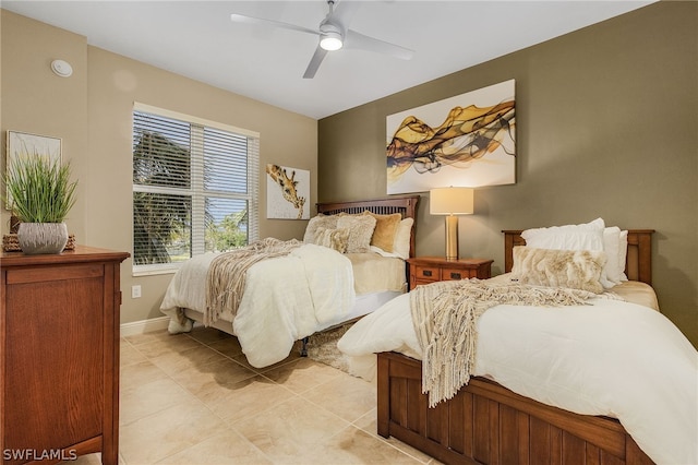 tiled bedroom featuring ceiling fan