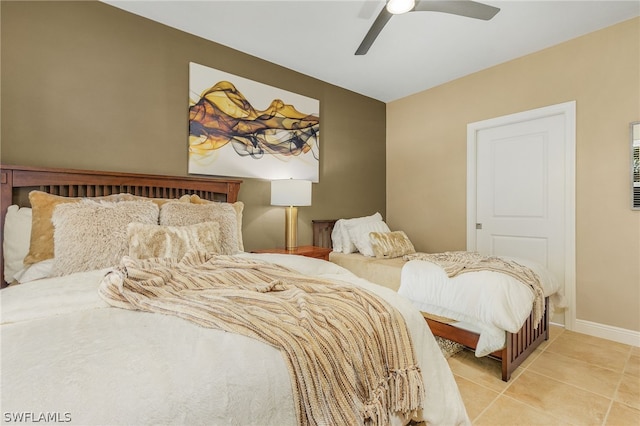 bedroom with ceiling fan and light tile floors