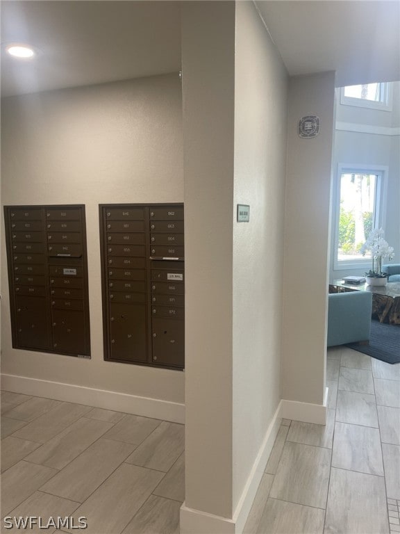 hallway featuring light tile floors and mail boxes