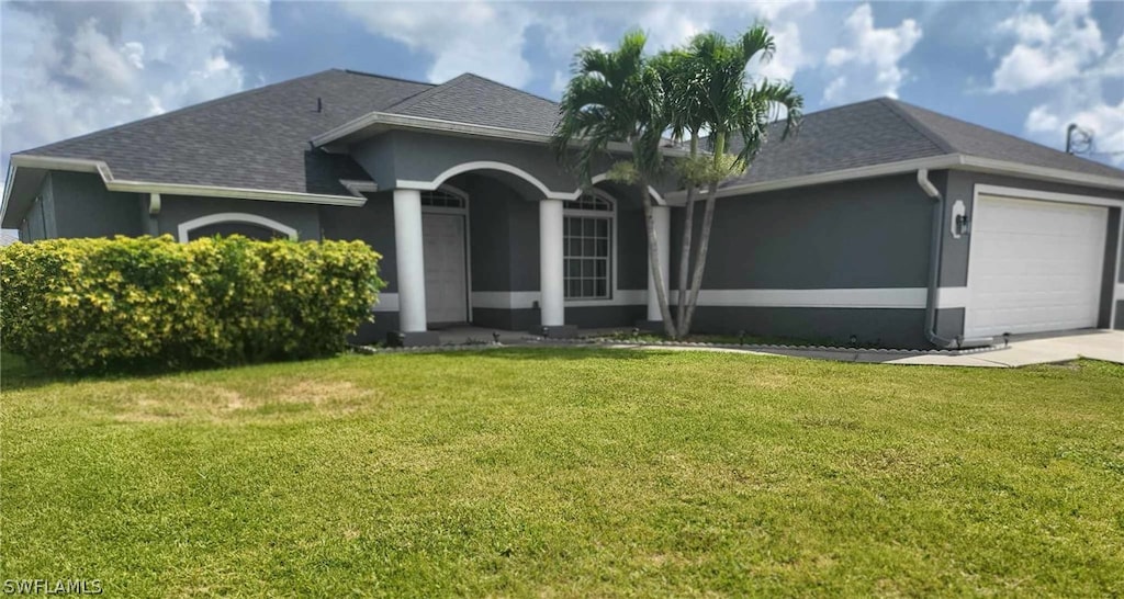 ranch-style house featuring a front lawn and a garage