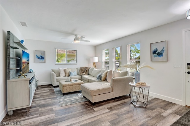 living room with dark wood-type flooring and ceiling fan