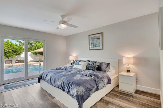 bedroom featuring access to outside, hardwood / wood-style floors, and ceiling fan