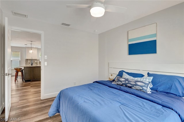 bedroom with hardwood / wood-style flooring and ceiling fan