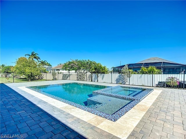 view of swimming pool featuring an in ground hot tub and a patio area