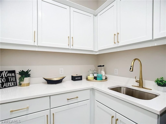 kitchen with white cabinetry and sink