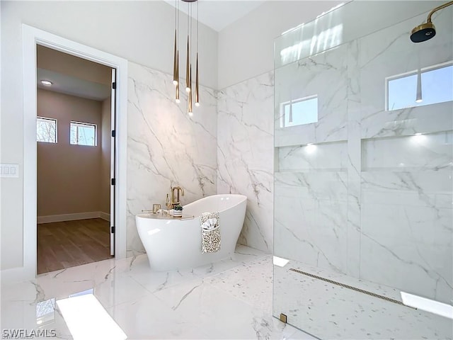 bathroom featuring shower with separate bathtub