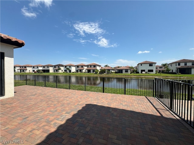 view of terrace with a water view and a balcony