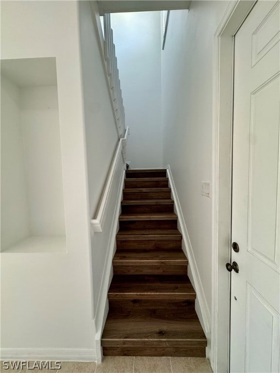 staircase featuring tile flooring