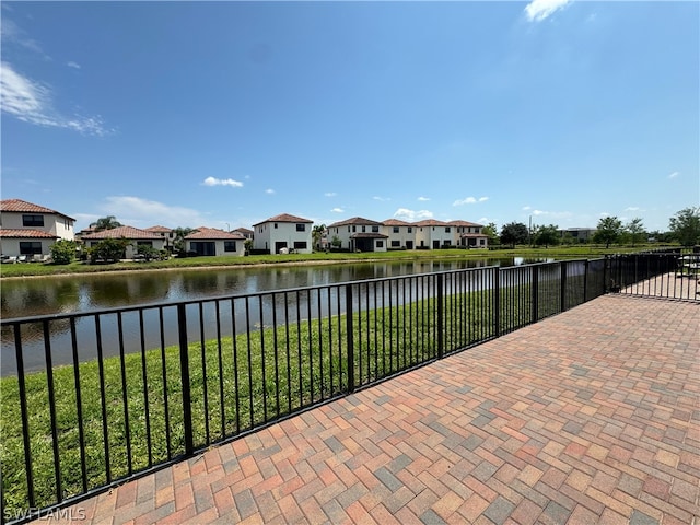 view of terrace with a balcony and a water view