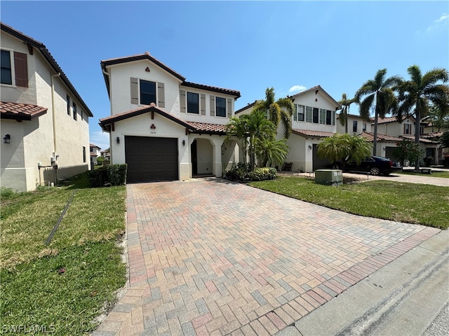 mediterranean / spanish-style house with a garage, a front yard, and central air condition unit