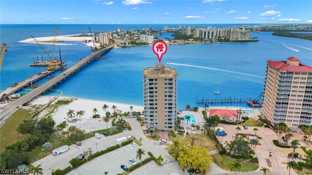 birds eye view of property featuring a water view and a view of the beach