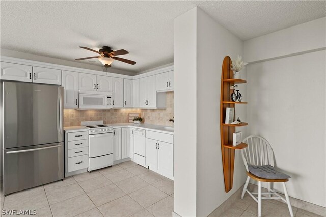 kitchen featuring white cabinets, decorative backsplash, light tile patterned floors, ceiling fan, and white appliances