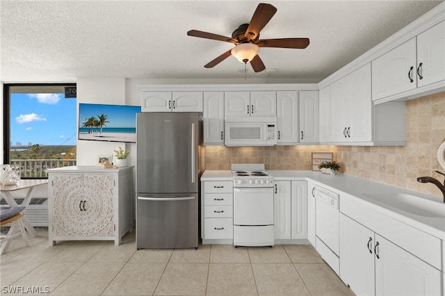 kitchen with white cabinetry, sink, white appliances, and backsplash