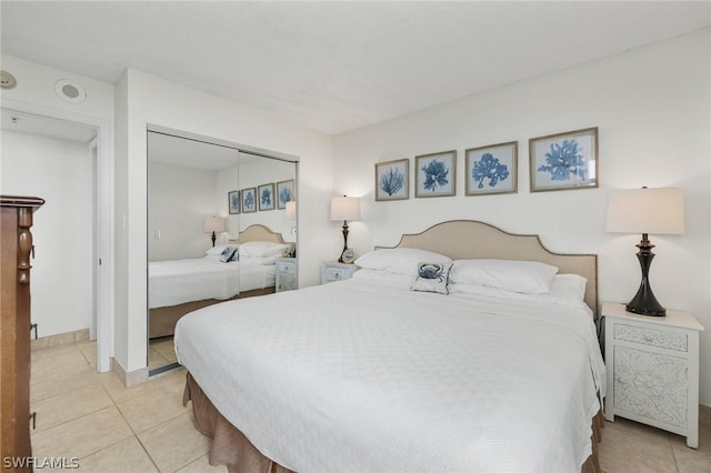 tiled bedroom with a closet