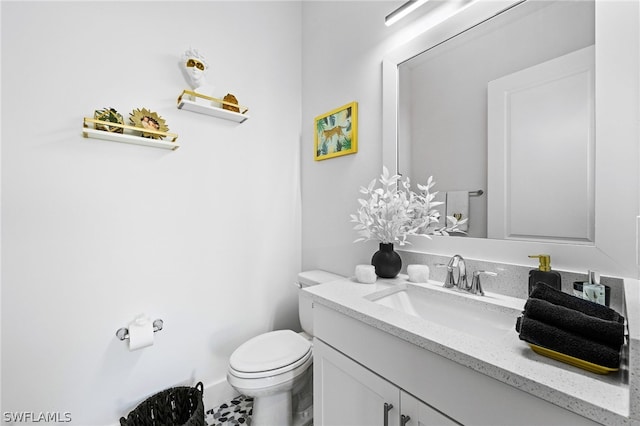 bathroom with vanity, toilet, and tile patterned floors