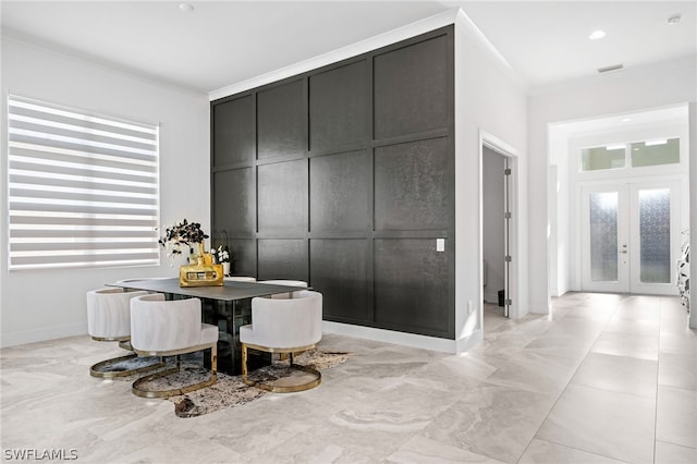 dining space with crown molding and french doors