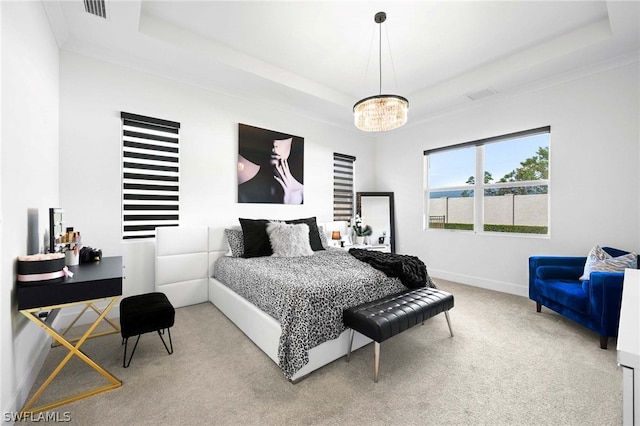 bedroom with carpet, a chandelier, and a raised ceiling