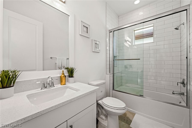 full bathroom with vanity, toilet, and enclosed tub / shower combo