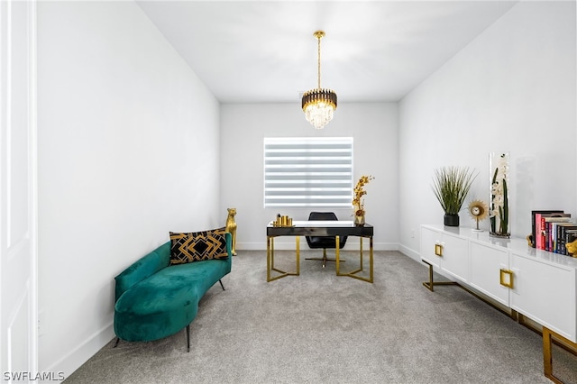 home office with carpet flooring and an inviting chandelier