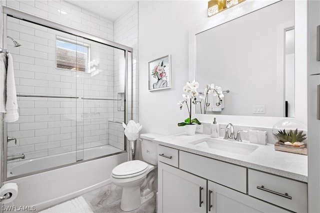 full bathroom featuring toilet, enclosed tub / shower combo, and vanity