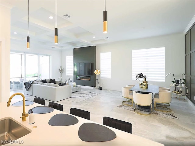 interior space featuring coffered ceiling and beamed ceiling