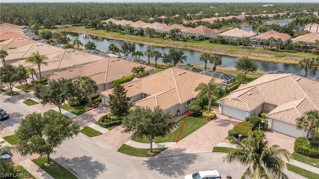 drone / aerial view featuring a residential view and a water view