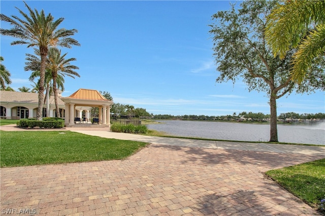 view of property's community featuring a gazebo, a lawn, and a water view