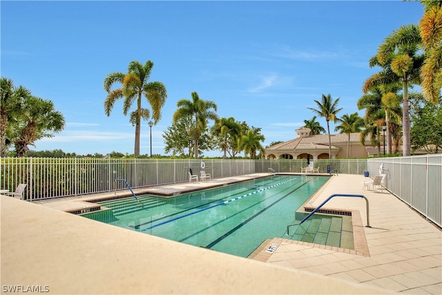 pool featuring a patio area and fence