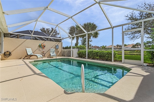 outdoor pool with a patio area and a lanai