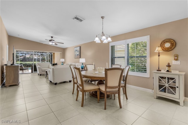 dining area with a wealth of natural light, visible vents, lofted ceiling, and light tile patterned floors