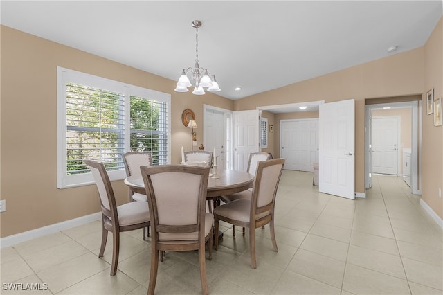 dining room with light tile patterned floors, baseboards, vaulted ceiling, and a chandelier