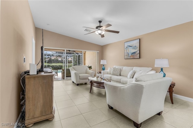 living area featuring light tile patterned floors, visible vents, baseboards, lofted ceiling, and ceiling fan