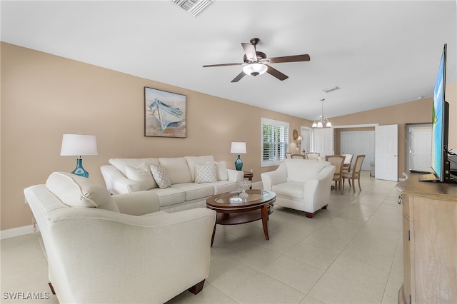 living room with lofted ceiling, light tile patterned flooring, visible vents, and ceiling fan with notable chandelier