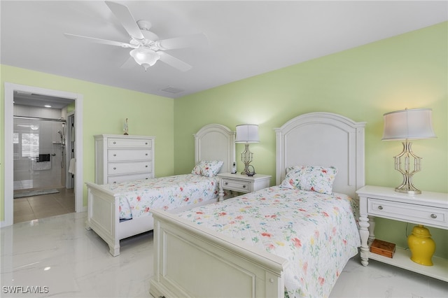 bedroom with marble finish floor, ceiling fan, and ensuite bathroom