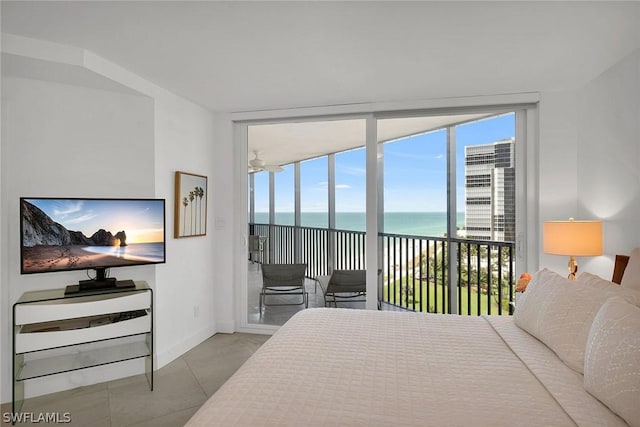 tiled bedroom with access to exterior and a water view