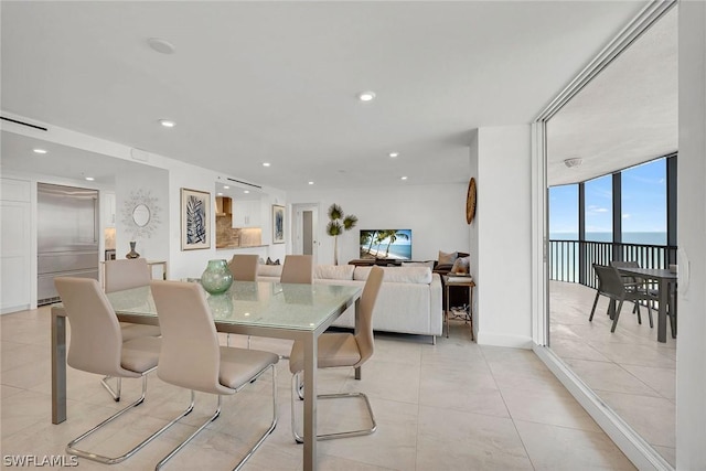 tiled dining space featuring floor to ceiling windows