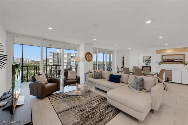 living room with floor to ceiling windows and light tile patterned floors