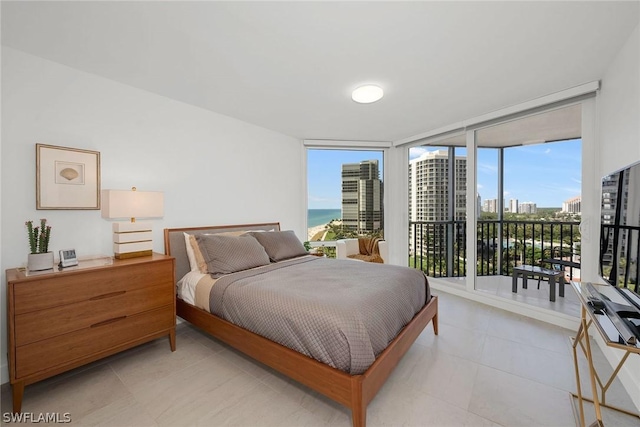 bedroom featuring expansive windows and access to outside