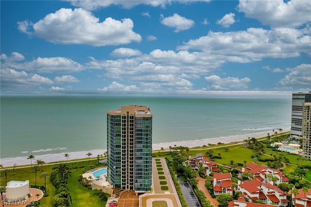 birds eye view of property with a water view and a view of the beach