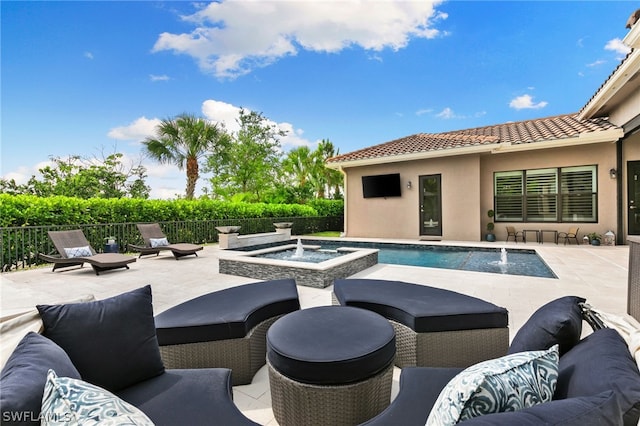 view of swimming pool with a patio, an outdoor hangout area, pool water feature, and an in ground hot tub