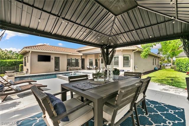 view of patio / terrace featuring a gazebo and a pool with hot tub