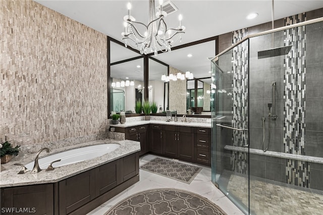 bathroom with vanity, a notable chandelier, and shower with separate bathtub