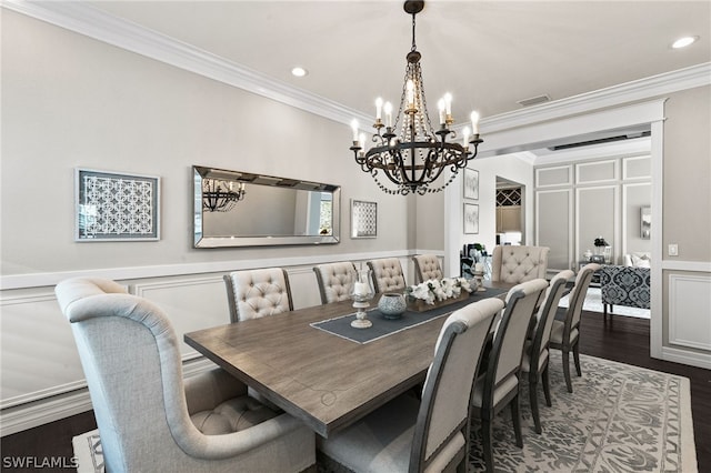 dining room with ornamental molding and dark hardwood / wood-style floors