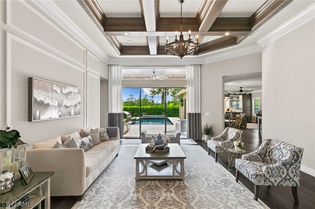 living room with ornamental molding, coffered ceiling, hardwood / wood-style flooring, and ceiling fan with notable chandelier