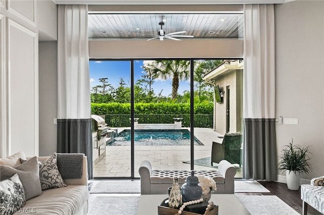 doorway to outside with hardwood / wood-style floors and ceiling fan