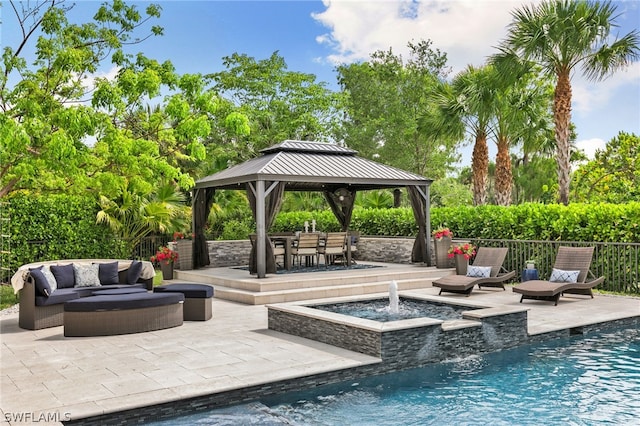 exterior space with a pool with hot tub, a gazebo, outdoor lounge area, and pool water feature