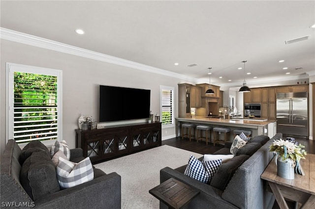 living room with ornamental molding and light hardwood / wood-style flooring