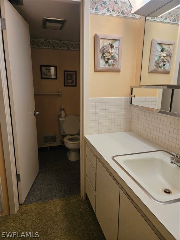 bathroom featuring vanity and toilet