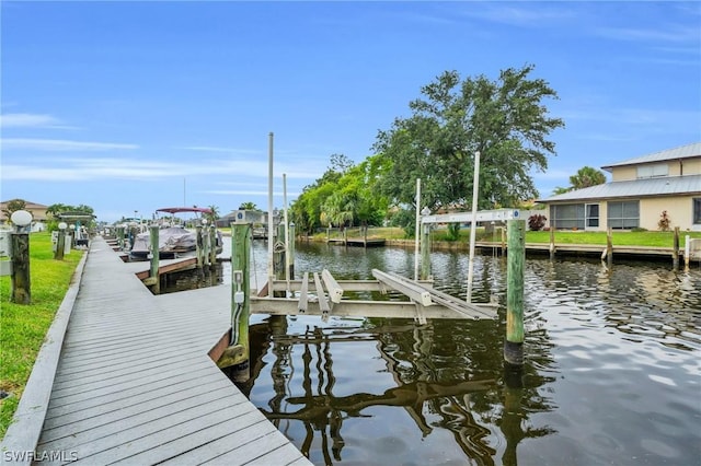 view of dock featuring a water view and boat lift