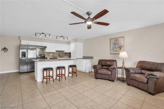 living room featuring ceiling fan and light tile patterned floors